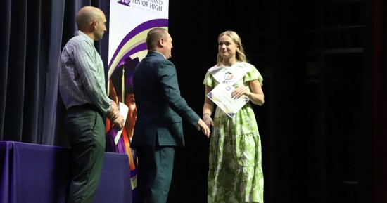 Addysen Waind, GISH Senior, receives her High Honors stole and certificate from Mr. Calvin Hubbard